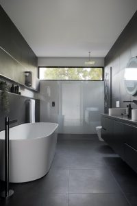modern and dark bathroom design with bathtub